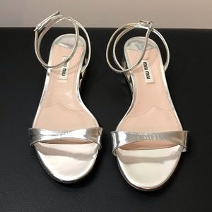 Miu Miu sandals with small, jeweled heels.